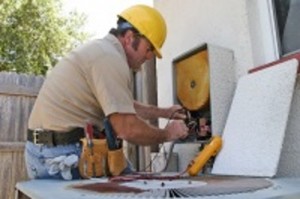 Man repairing air conditioning unit