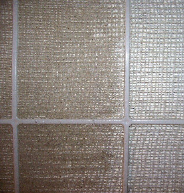 Dirty air filter showing blocked airflow, highlighting the need for cleaning or replacement to maintain AC efficiency.