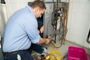 Plumber checking a furnace.