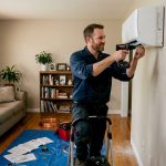 Technician installs mini-split indoor unit
